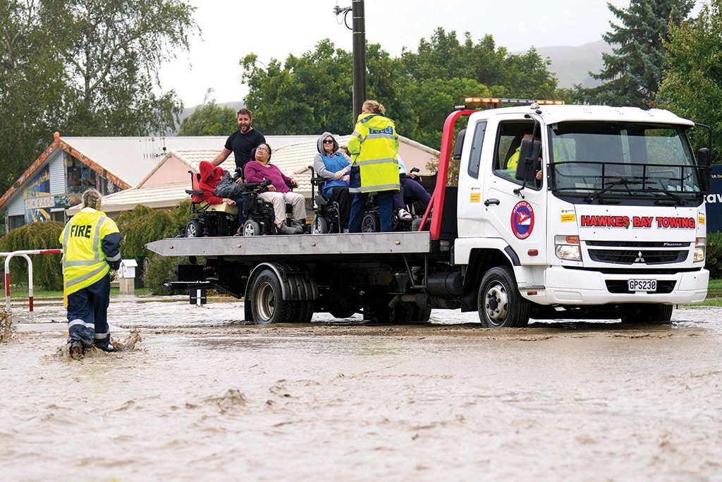 NAPIER: Photo taken on February 14, 2023 shows a group of wheelchair-bound people being rescued from a flooded area in the North Island city of Napier. New Zealand declared a national state of emergency on February 14 as Cyclone Gabrielle swept away roads, inundated homes and left more than 100,000 people without power. – AFP