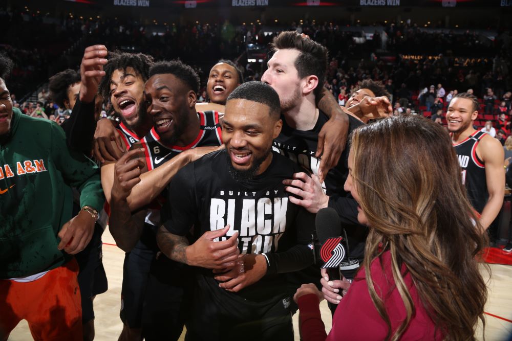 PORTLAND: Damian Lillard of the Portland Trail Blazers is cheered by teammates after he scored a career-high 71 points during the game against the Houston Rockets on February 26, 2023 at the Moda Center Arena in Portland, Oregon. - AFP