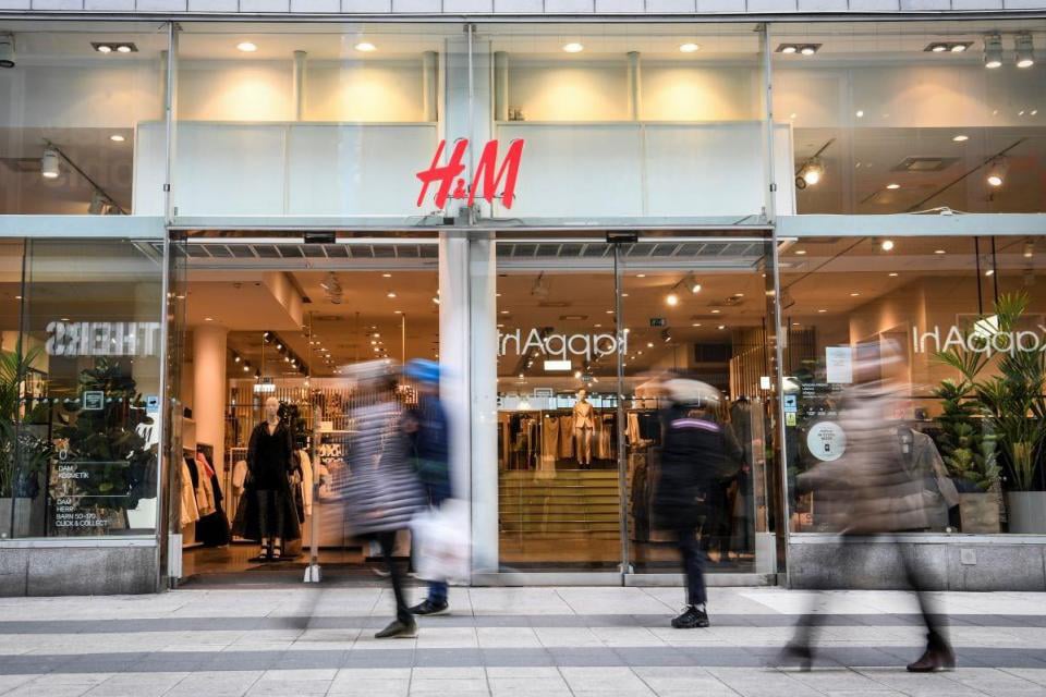 STOCKHOLM: Shoppers walk past a fashion store of H&amp;M in Stockholm, Sweden. -- AFP