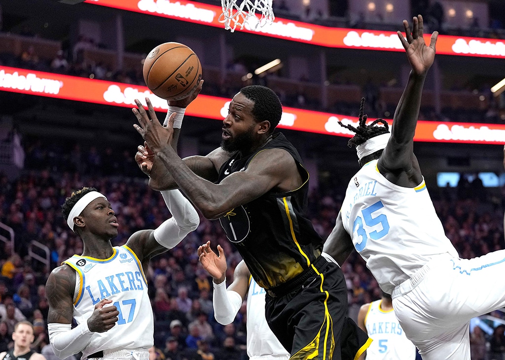 SAN FRANCISCO: JaMychal Green of the Golden State Warriors going up to shoot gets fouled from behind by Wenyen Gabriel of the Los Angeles Lakers at Chase Center on Feb 11, 2023. - AFP