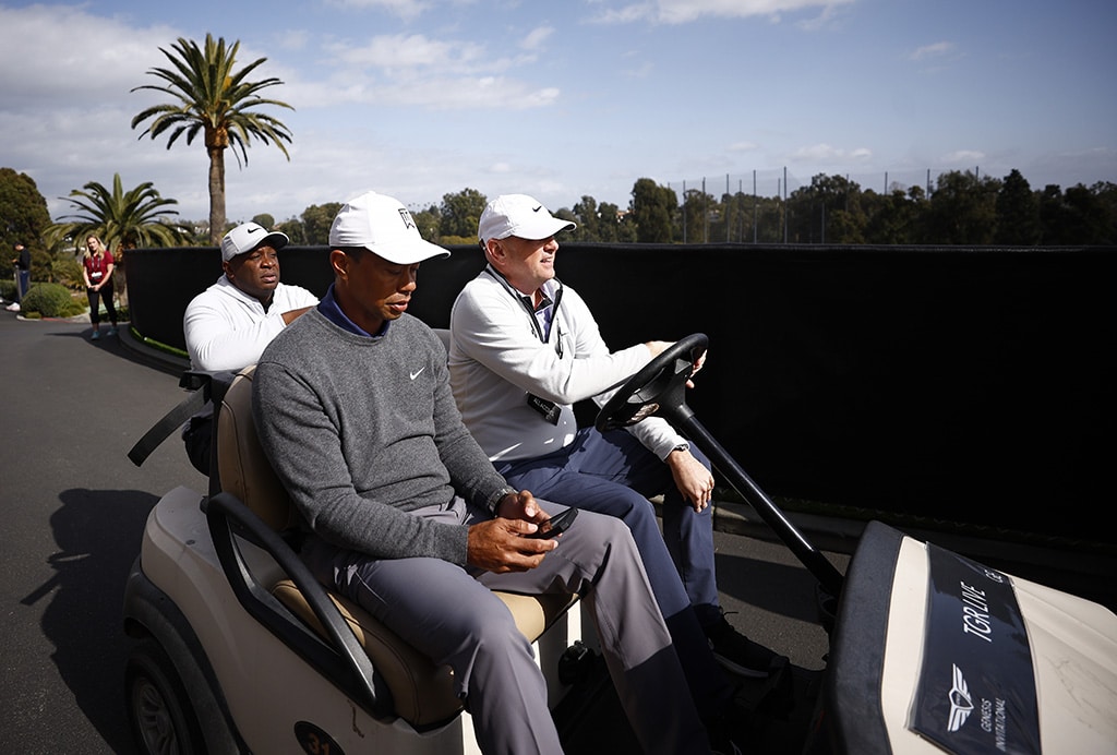 CALIFORNIA: Tiger Woods of the United States and Rob McNamara, Executive Vice President at TGR, ride in a cart prior to The Genesis Invitational at Riviera Country Club on February 14, 2023. — AFP