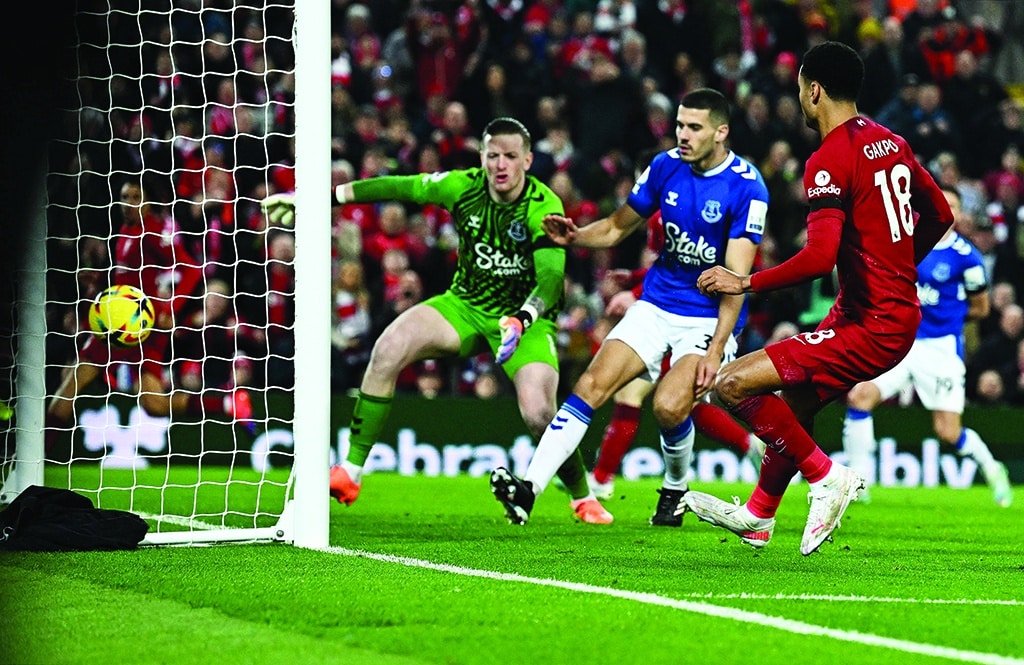 LIVERPOOL: Liverpool's Dutch striker Cody Gakpo (right) scores the team's second goal past Everton's English goalkeeper Jordan Pickford during the English Premier League football match between Liverpool and Everton on February 13, 2023. - AFP