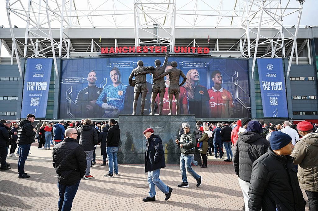 MANCHESTER: Fans arrive outside of Old Trafford stadium in Manchester north west England on February 19, 2023. - AFP