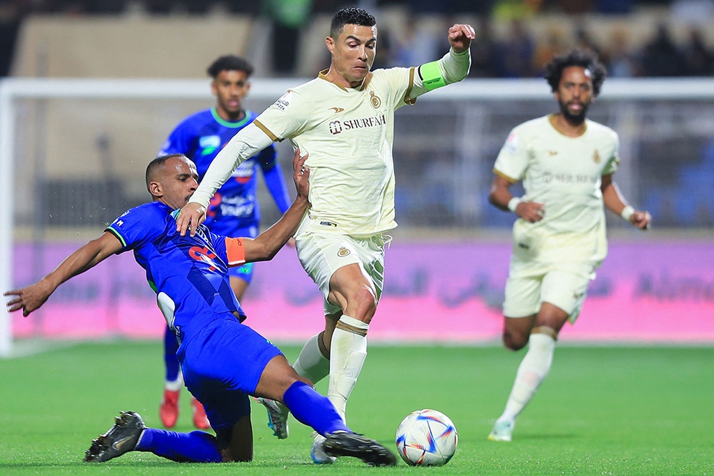 AL-HASA: Nassr’s Portuguese forward Cristiano Ronaldo (center) dribbles past Fateh’s Saudi midfielder Mohammed Al-Fuhaid (left) during the Saudi Pro League football match between Al-Fateh and Al-Nassr on February 3, 2023. – AFP