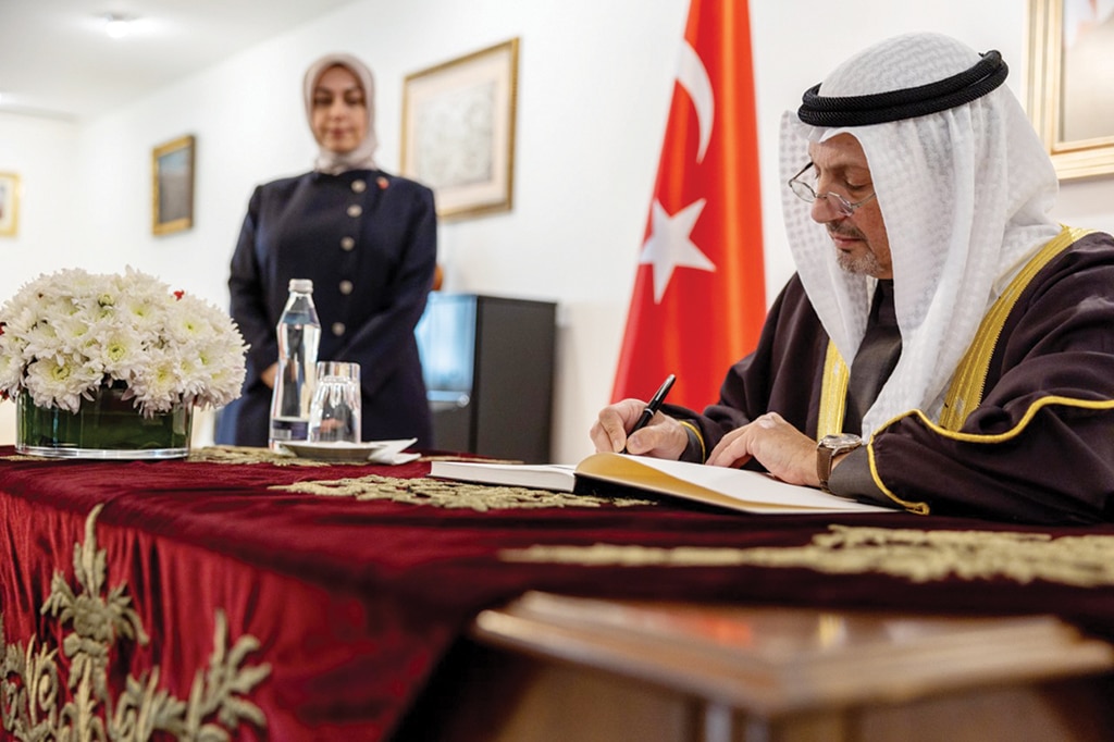 KUWAIT: Kuwait's Foreign Minister Sheikh Salem Al-Abdullah Al-Sabah signs a book of condolences as Turkish Ambassador Tuba Nur Sonmez looks on on Feb 8, 2023. - KUNA