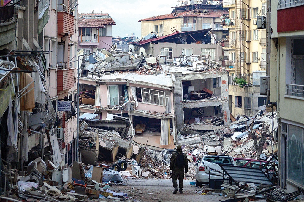 HATAY, Turkey: A Turkish soldier walks among destroyed buildings on Feb 12, 2023. - AFP