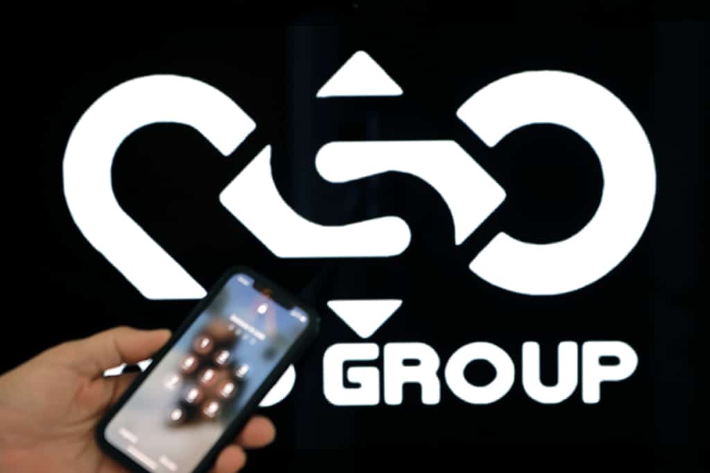 A photographic illustration shows a mobile phone near the NSO Group company logo on February 9, 2022 in the Israeli city of Netanya. - Israel's ground-breaking surveillance technology was once feted as a prized export bolstering diplomatic ties abroad, but reports the secret spyware was also turned on citizens at home has trigged domestic outrage. Recent bombshell allegations in Israeli media centre on the controversial Pegasus malware made by the Israeli firm NSO, which can turn a phone into a pocket spying device. (Photo by JACK GUEZ / AFP)