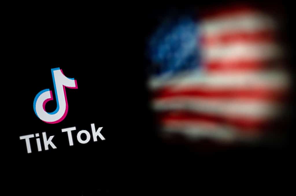 BEIJING: File illustration photo taken on September 14, 2020 shows the logo of the social network application TikTok (L) and a US flag (R) shown on the screens of two laptops in Beijing. The White House gave federal agencies 30 days to purge Chinese-owned video-snippet sharing app TikTok from all government-issued devices. - AFP