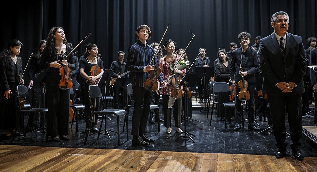 Japanese-born American violinist Midori Goto (center) and music students from the National Institute of Music of Afghanistan (Anim) stand up at the end of a concert at the music conservatory of Braga, north of Portugal.— AFP photos