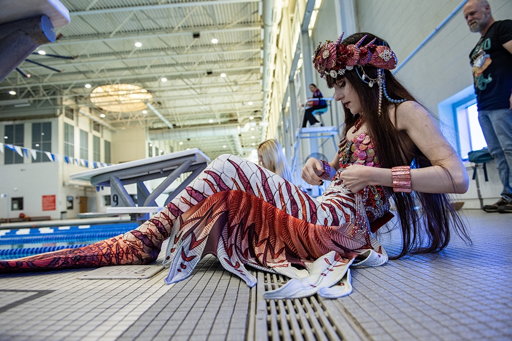 A person who goes by the mermaid name Merlot prepares for a group photo and group swim during the MerMagic Convention at the Freedom Aquatic &amp; Fitness Center in Manassas, Virginia.— AFP photos 
