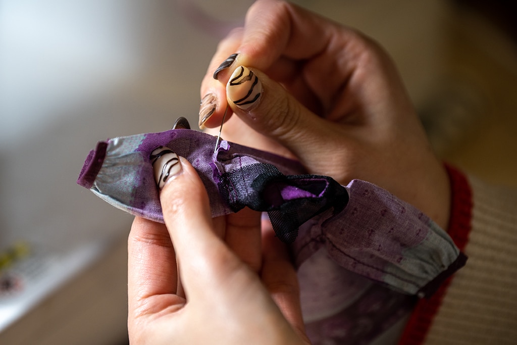This photo shows Ryoko Baba sewing a costume for her Licca-chan dolls. 