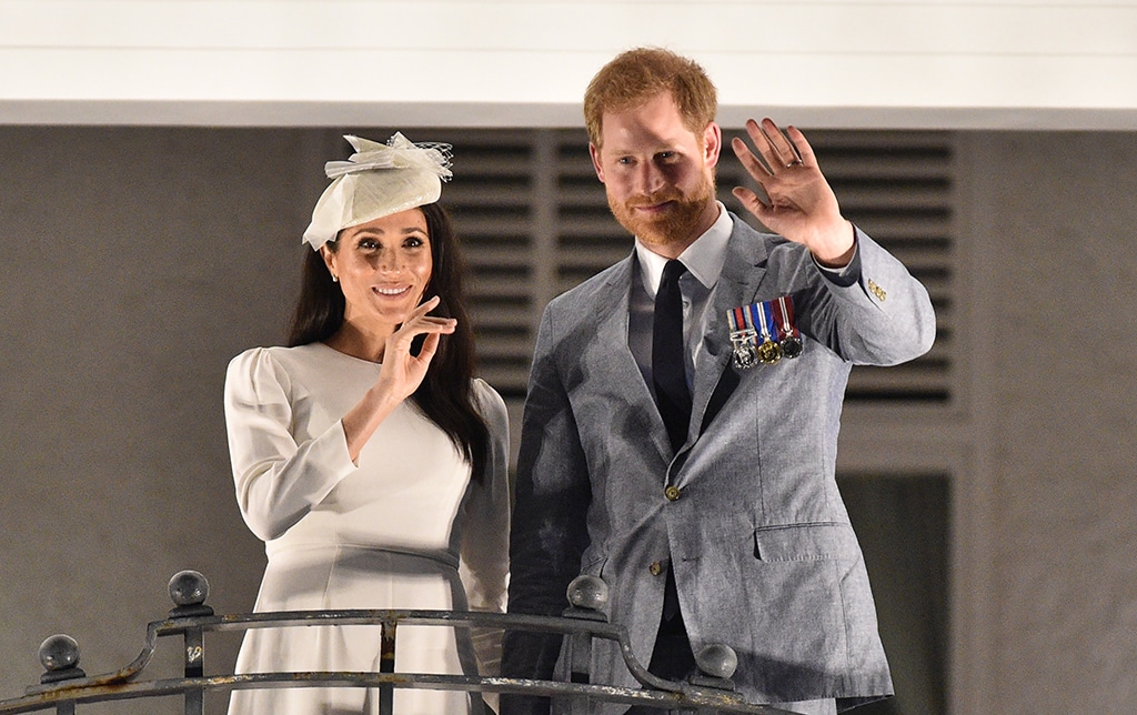 Britain's Prince Harry (right) and and his wife Meghan, the Duchess of Sussex (left) wave from the balcony of the Grand Pacific Hotel in Suva, Fiji.— AFP  