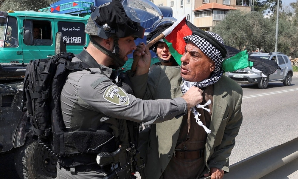 HUWARA: A member of the Zionist security forces attacks a Palestinian protester at the entrance of Huwara in the occupied West Bank, on March 3, 2023, following deadly violence by Zionist settlers. - AFP 