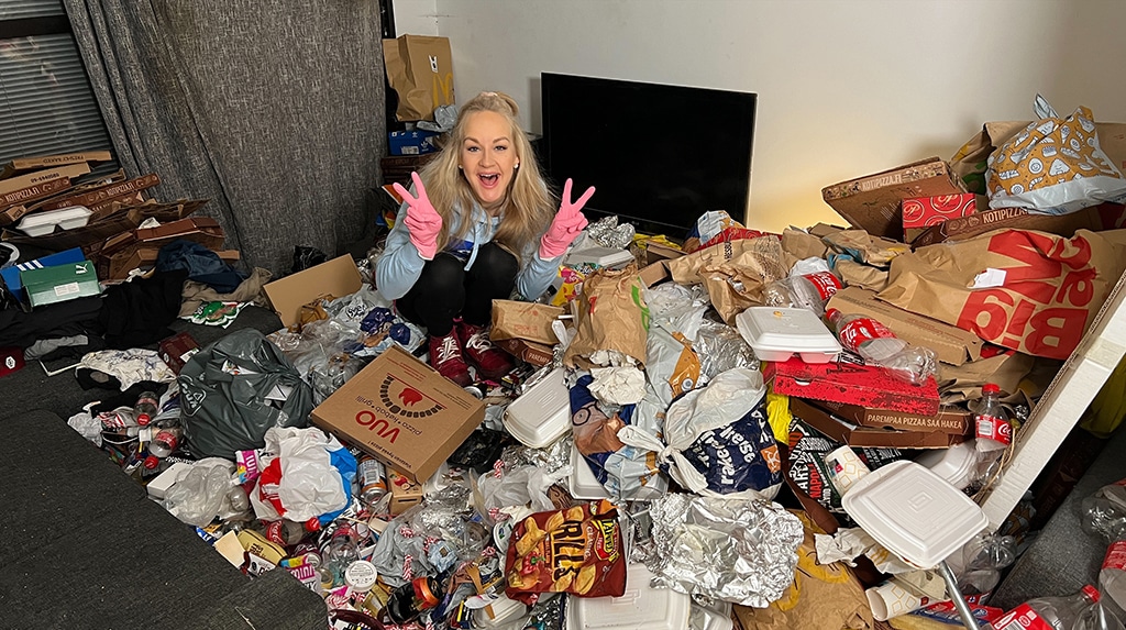 This handout photo shows Finnish TikTok cleanfluencer Auri Kananen wearing pink gloves and making victory signs as she sits on a pile of trash and food remains in a flat in Helsinki, Finland.- AFP photos