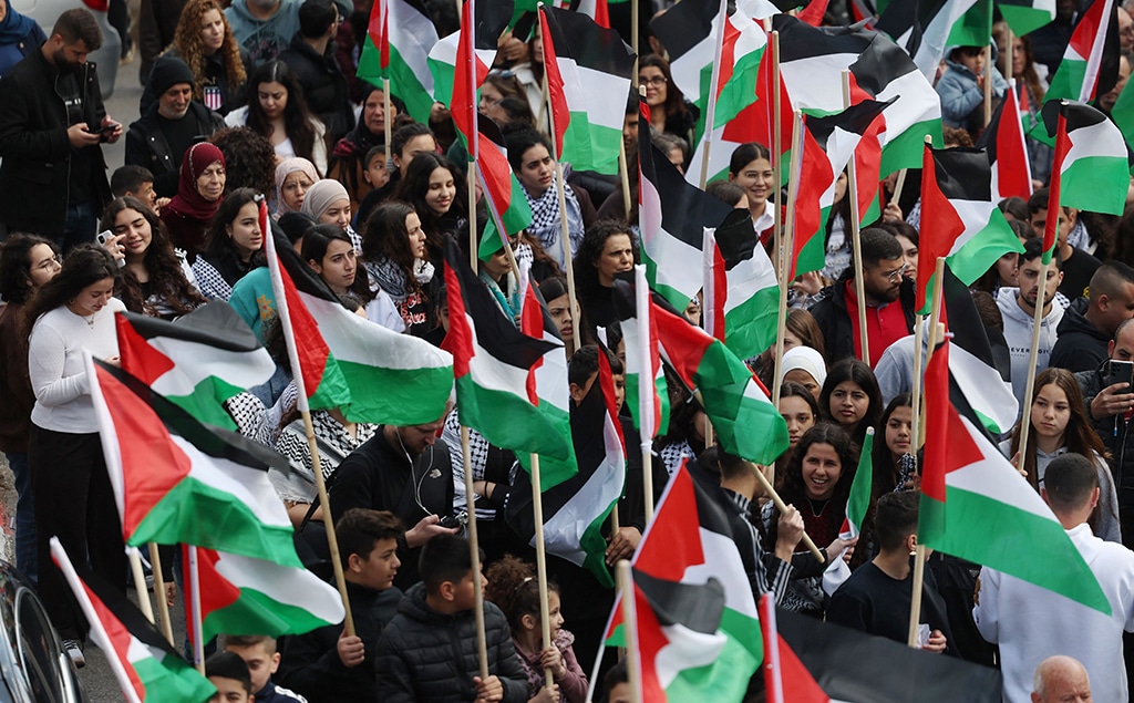 SAKHNIN: Protesters wave Palestinian flags during a demonstration marking the annual Land Day in the northern Arab-Zionist town of Sakhnin on March 30, 2023. Land Day commemorates the events of March 30, 1976, when Zionist troops shot and killed six people among Arab Zionists and Palestinians protesting land confiscations. — AFP