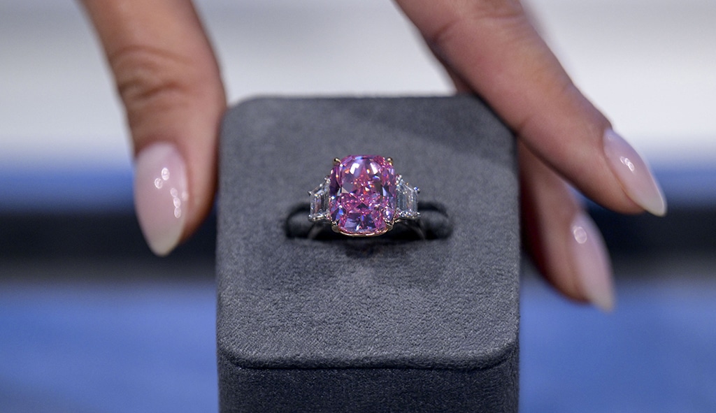 A model holds a 10.57 carat vivid pink diamond, with an estimated value of moe than 5 million US dollars, during a press preview at Sotheby's in New York City.- AFP photos