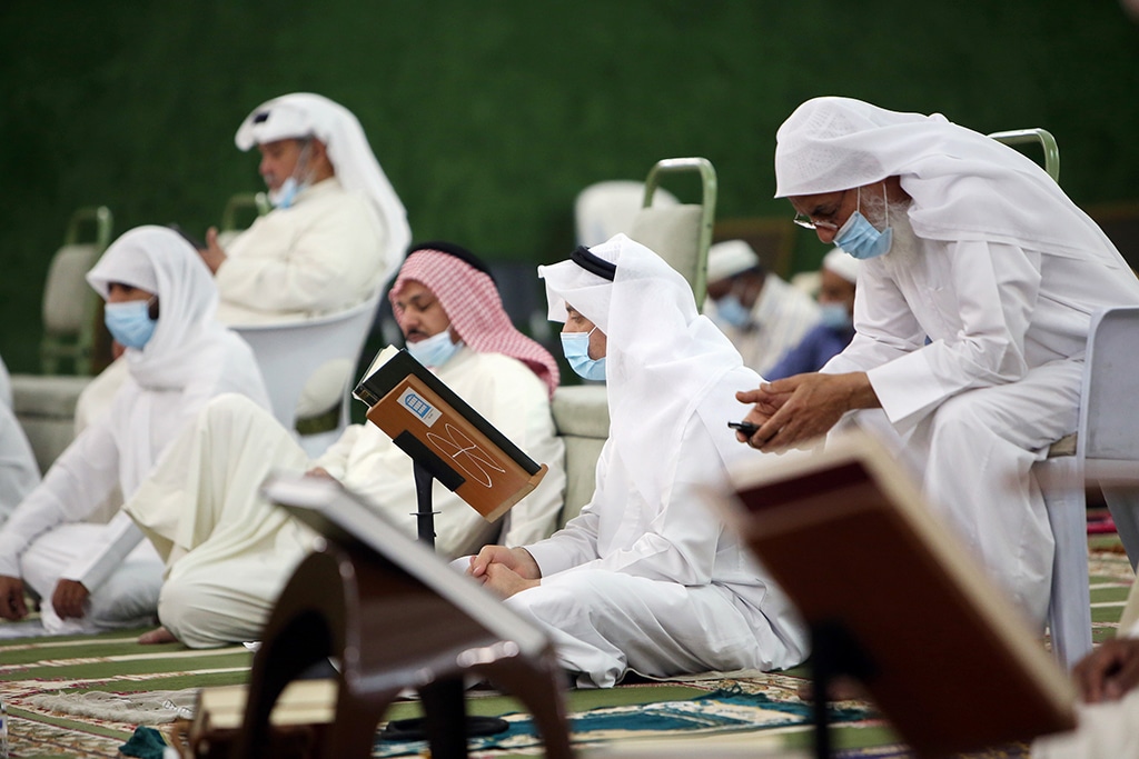 Muslim men read the Quran at Fatmah Mosque in the Kuwait City just before daybreak, early on May 9, 2021, during Laylat Al-Qadr, which falls on the 27th day of the holy month of Ramadan. Laylat Al-Qadr, the most important prayer of the fasting month, is the night when Muslims commemorate the revelation of the first verses of the Quran to their Prophet Mohammed (PBUH) through the Angel Gabriel. Muslims spend the night in worship and devotion, praying for the souls of the dead. — Photo by Yasser Al-Zayyat