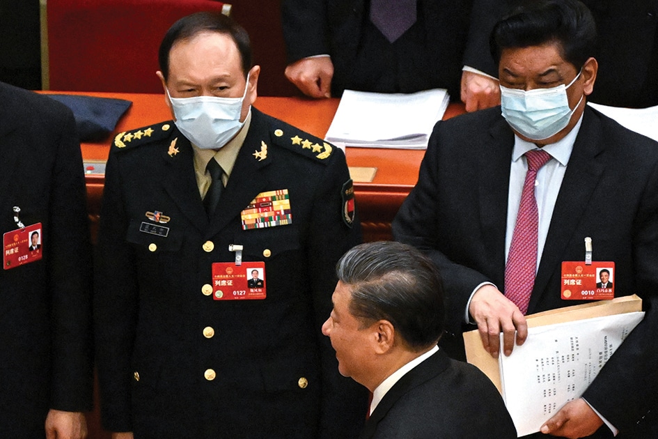 BEIJING: China's President Xi Jinping walks past delegates including China's Defence Minister Wei Fenghe (L) after the opening session of the National People's Congress (NPC) at the Great Hall of the People in Beijing on March 5, 2023.- AFP