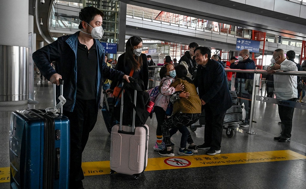 BEIJING: Passengers walk through the arrivals hall for international flights at the Capital International Airport in Beijing on March 14, 2023. China will once again start issuing a range of visas to foreigners on March 15, in a major easing of travel restrictions. - AFP