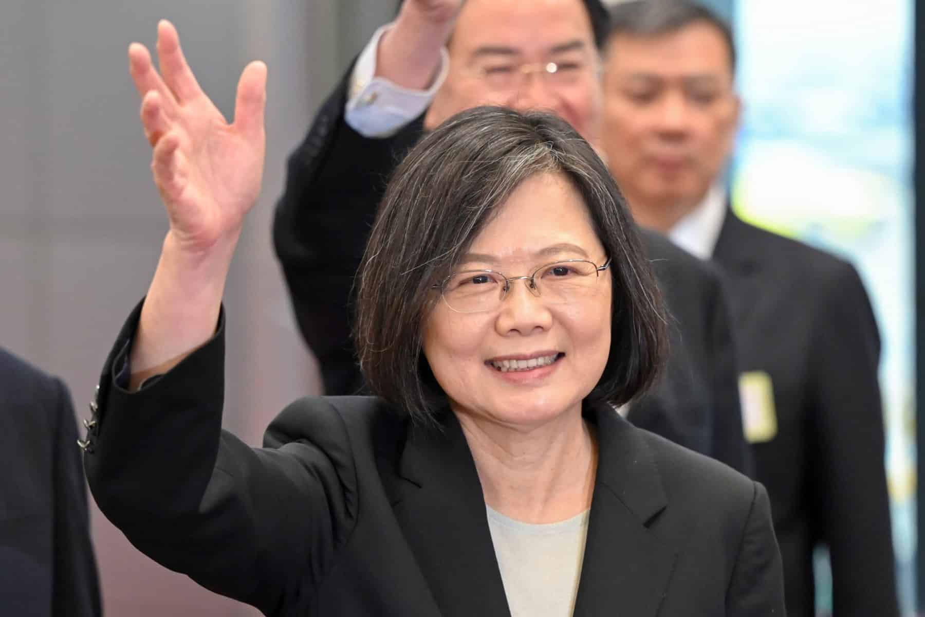 Taiwan President Tsai Ing-wen waves as she arrives at the boarding gate of the international airport in Taoyuan on March 29, 2023. - Tsai was due to leave for the United States on March 29, a stop on her way to firm ties with Guatemala and Belize after China snapped up another of the self-ruled island's few diplomatic allies last week. (Photo by Sam Yeh / AFP)