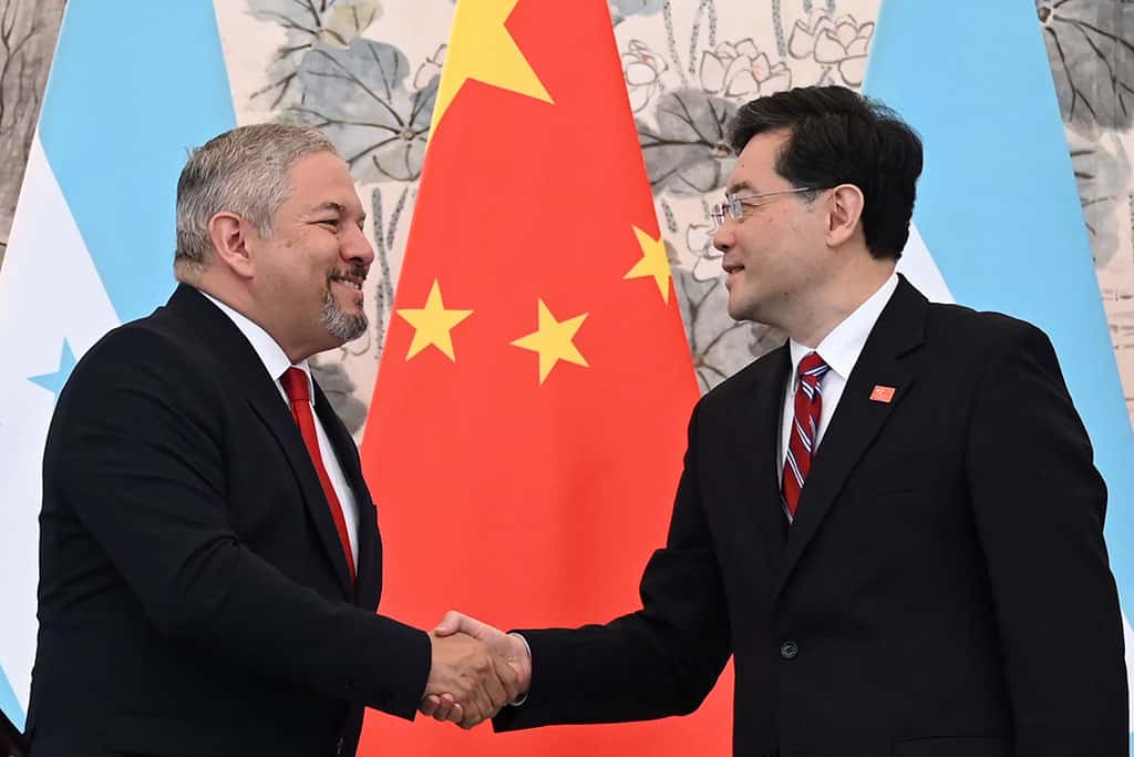 BEIJING: Honduras Foreign Minister Eduardo Enrique Reina (left) and Chinese Foreign Minister Qin Gangnshake hands following the establishment of diplomatic relations between the two countries. — AFP