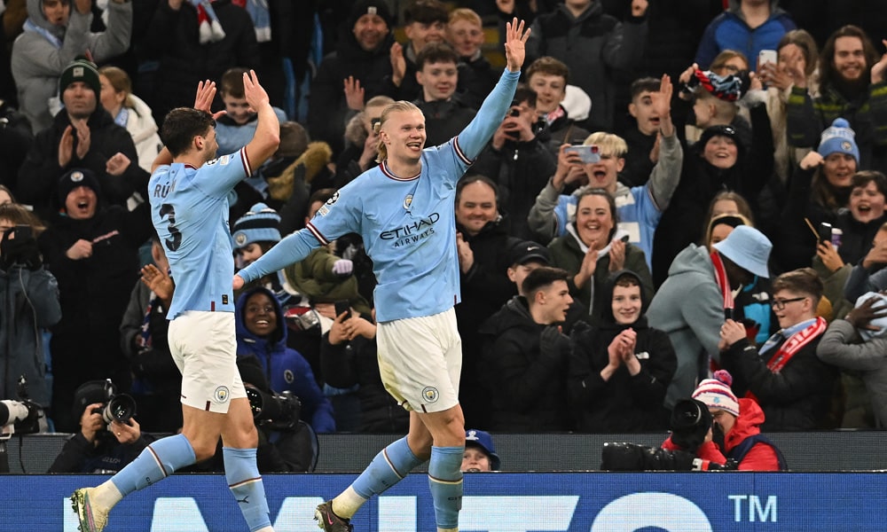 Manchester City's Norwegian striker Erling Haaland (R) celebrates scoring the team's sixth goal, his fifth, during the UEFA Champions League round of 16 second-leg football match between Manchester City and RB Leipzig at the Etihad Stadium in Manchester, north west England, on March 14, 2023.
