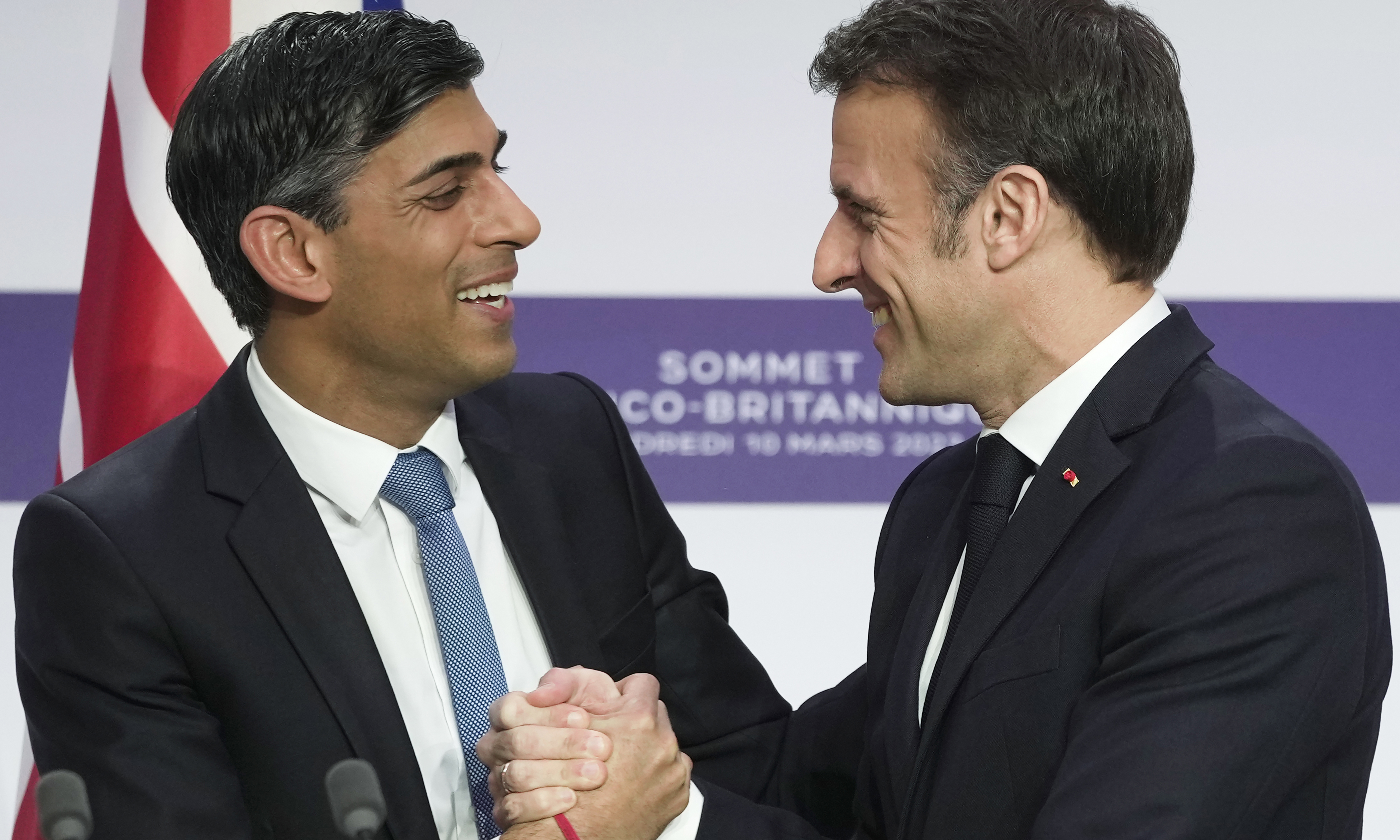 PARIS: Britain's Prime Minister Rishi Sunak (L) and France's President Emmanuel Macron (R) shake hands during a joint press conference at the end of the French-British summit. - AFP