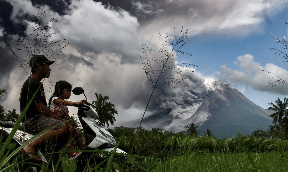 Thick smoke rises during an eruption from Mount Merapi, Indonesia, most active volcano, as seen from Tunggularum village in Sleman on March 11, 2023.
