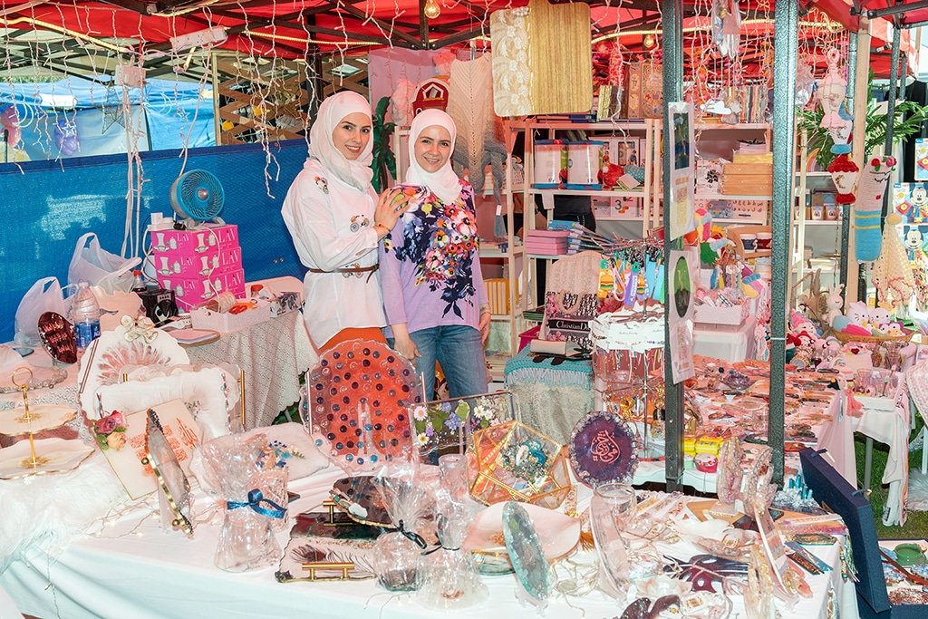 KUWAIT: Two participants display artistic pieces at the exhibition. – KUNA photos