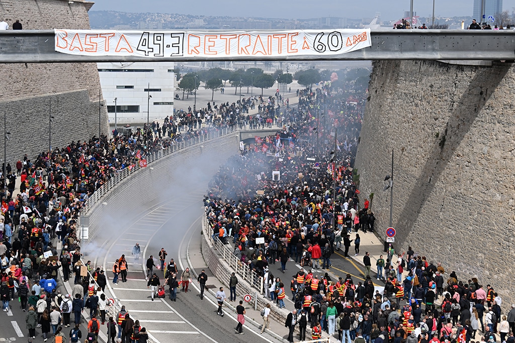 MARSEILLE, France: Protestors walk during a demonstration, a week after the government pushed a pensions reform through parliament without a vote, using the article 49.3 of the constitution, in Marseille, southeastern France, on March 23, 2023. — AFP