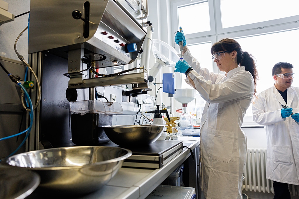 FREIBERG: French scientist Anna Vanderbruggen (center) selects chemicals with a pipette next to the graphit recycling system in a laboratory of the Helmholtz Institute Freiberg for Resource Technology in Freiberg, eastern Germany on February 27, 2023. — AFP