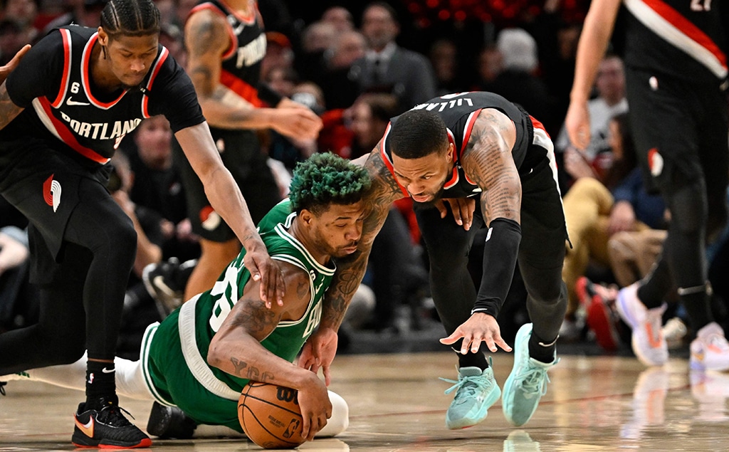 PORTLAND: Marcus Smart #36 of the Boston Celtics and Damian Lillard #0 of the Portland Trail Blazers go after a loose ball during the fourth quarter at the Moda Center on March 17, 2023.- AFP