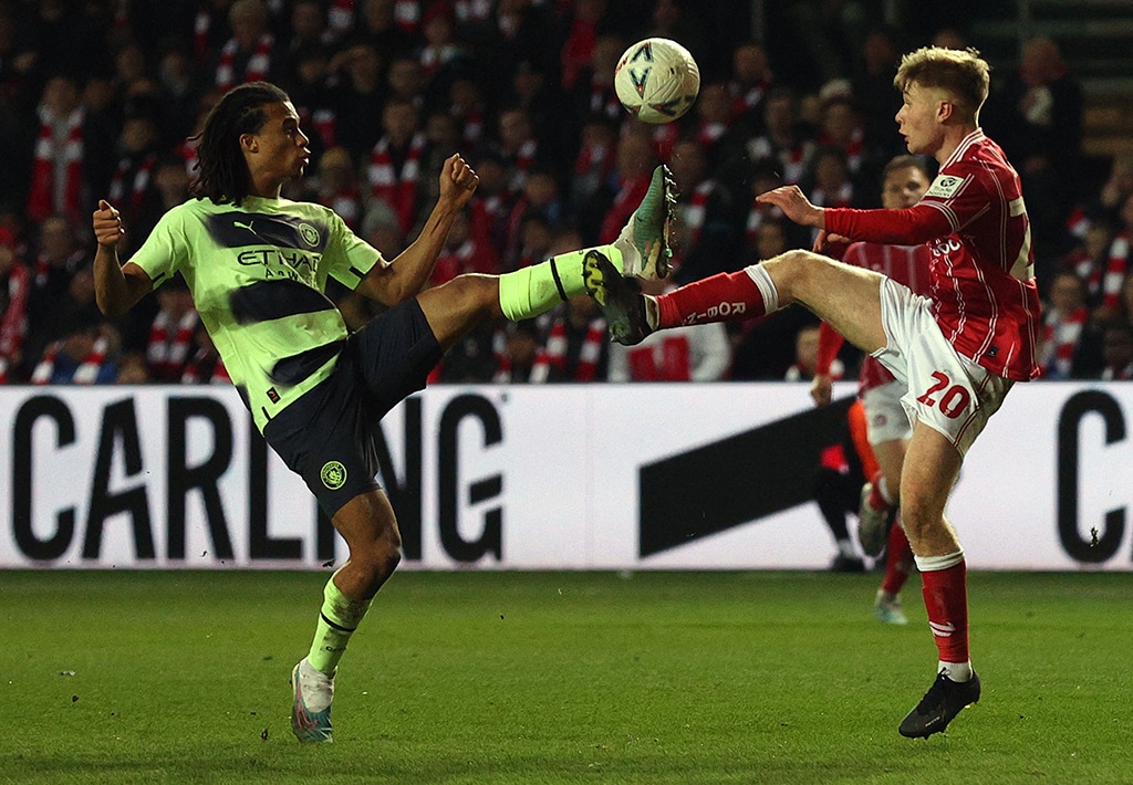 BRISTOL: Manchester City's Dutch defender Nathan Ake (left) vies with Bristol City's English striker Sam Bell during the English FA Cup fifth round football match between Bristol City and Manchester City at Ashton Gate in Bristol on February 28, 2023. - AFP