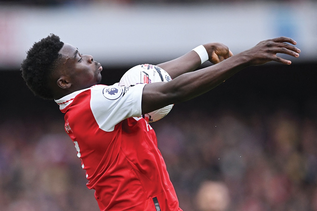 LONDON: Arsenal's English midfielder Bukayo Saka controls the ball during the English Premier League football match between Arsenal and Crystal Palace on March 19, 2023. - AFP