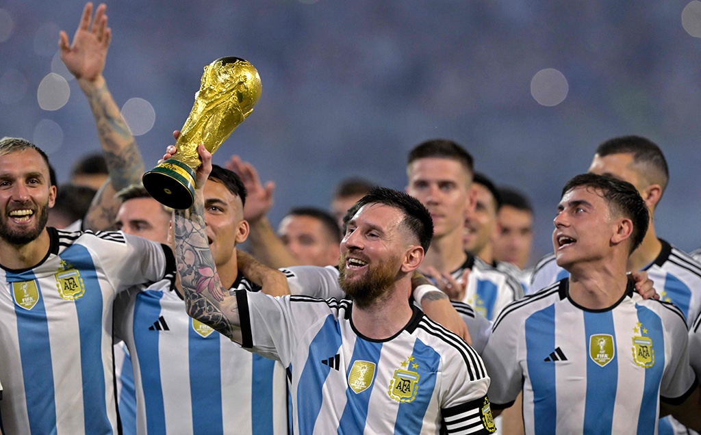 SANTIAGO DEL ESTERO: Argentina’s forward Lionel Messi (center) raises a replica of the World Cup trophy next to his teammates during a recognition ceremony for the World Cup-winning players, following the friendly football match between Argentina and Curacao on March 28, 2023. — AFP