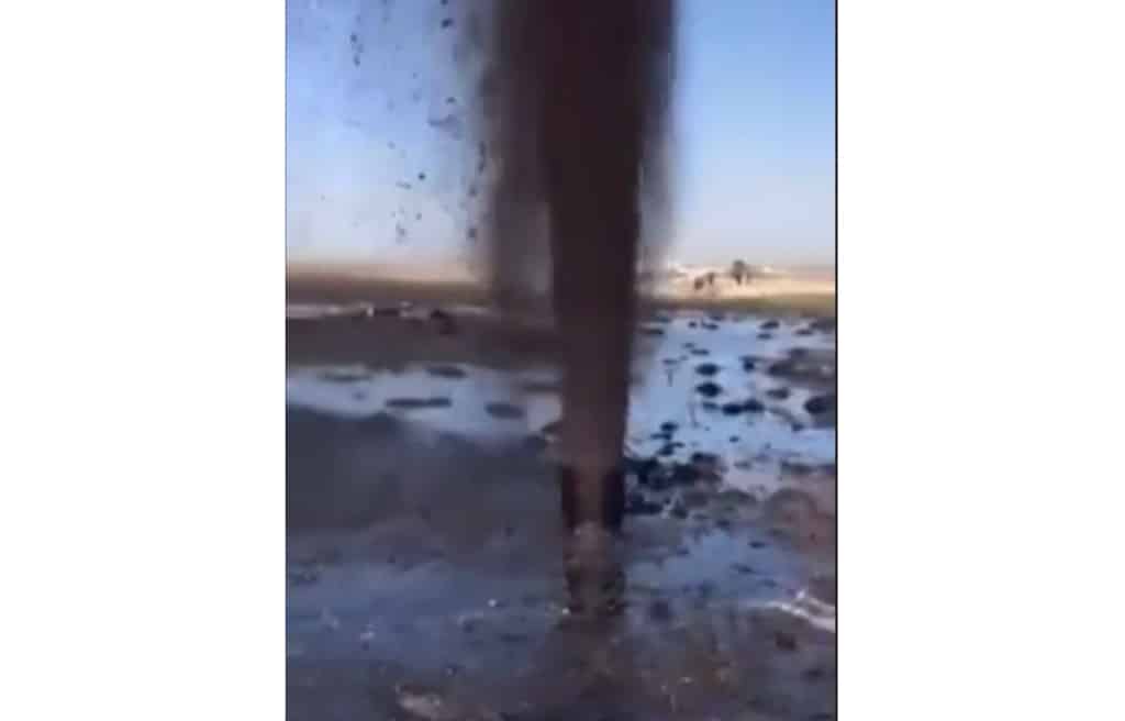 KUWAIT: This grab from video footage shows a pipe spewing large amounts of oil onto barren land at a location in the west of Kuwait on March 20, 2023. – AFP