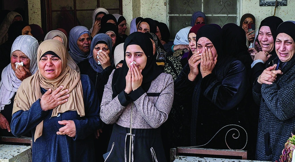 JENIN: Relatives of Ziad Al-Zaraini, a Palestinian who was killed the previous day during a Zionist army raid in the Jenin camp for Palestinian refugees, react as mourners gather outside his house on March 8, 2023. – AFP