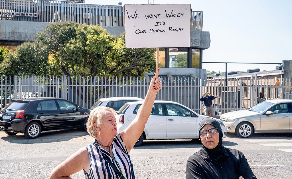 JOHANNESBURG: A woman holds up a placard reading ‘We want water, its our human right’ as residents protest outside the offices of Johannesburg Water’s Southdale Depot in the south of Johannesburg on World Water Day. — AFP