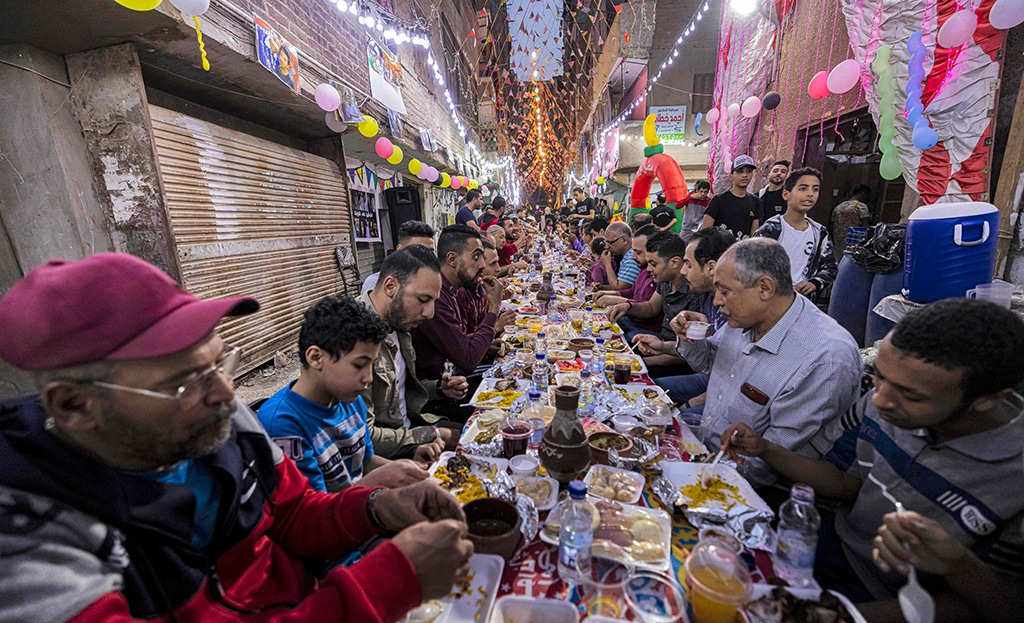 CAIRO: In this file photo taken on April 16, 2022, Muslims gather along street-long tables to break their Ramadan fast together in the Matariya suburb. — AFP