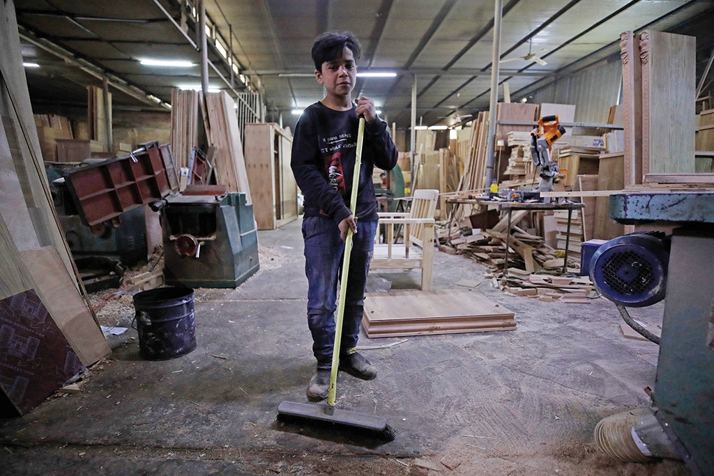 BAGHDAD: Haydar Karar, 13, works at a carpentry shop in the Iraqi capital on Jan 31, 2023. - AFP