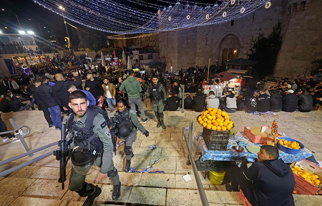 Zionist security forces patrol as Palestinians gather outside the Damascus Gate in Jerusalem’s Old City during the Muslim fasting month of Ramadan. — AFP