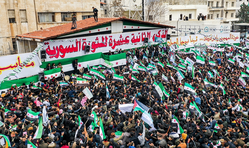 IDLIB: This aerial view shows people gathering for a rally to mark the 12th anniversary of the start of the uprising against Syrian president Bashar Al-Assad and his government in this rebel-held northwestern city on March 15, 2023. - AFP