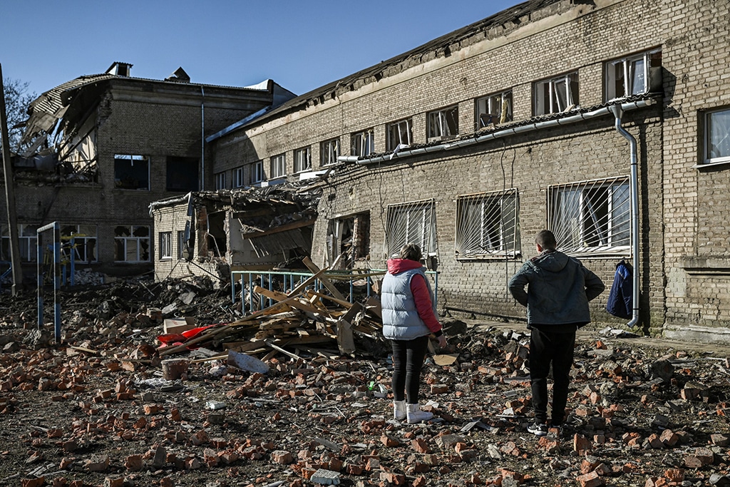 KRAMATORSK: People stand outside a destroyed school after a missile strike in Kramatorsk, Dombass regions, on March 6, 2023, amid Russian invasion of Ukraine. – AFP
