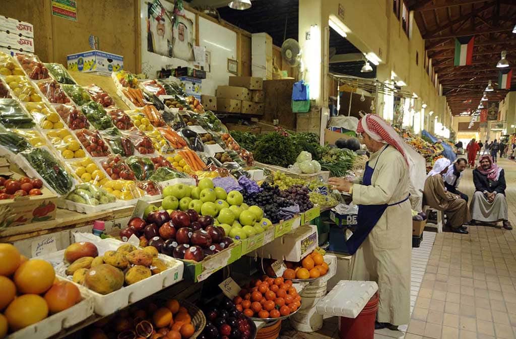 KUWAIT: A vendor puts fresh vegetables and fruits for display at his stall in Souk Mubarakiya in this file photo. – Photo by Yasser Al-Zayyat