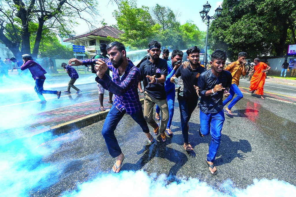 COLOMBO: Police use tear gas to disperse anti-government demonstrators and university students during a protest demanding the release of Inter University Students' Federation leaders and the country's economic crisis, in Colombo on March 8, 2023. - AFP