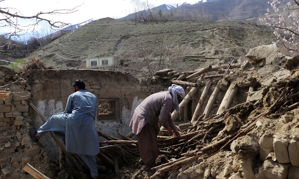 JURM, AFGHANISTAN: Residents clear debris from a damaged a house at Sooch village in Jurm district of Badakhshan Province on March 22, 2023, following an overnight earthquake. At least 13 people were killed in Afghanistan and Pakistan by a strong earthquake felt across thousands of kilometers. – AFP
