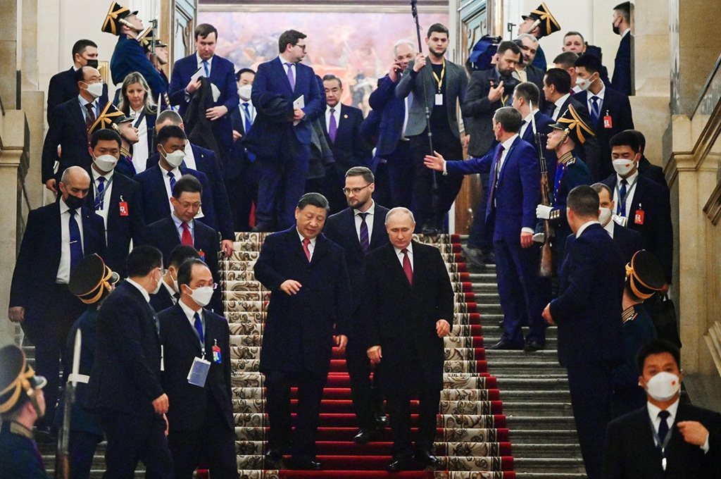MOSCOW: Russian President Vladimir Putin and China's President Xi Jinping leave after a reception following their talks at the Kremlin in Moscow. - AFP