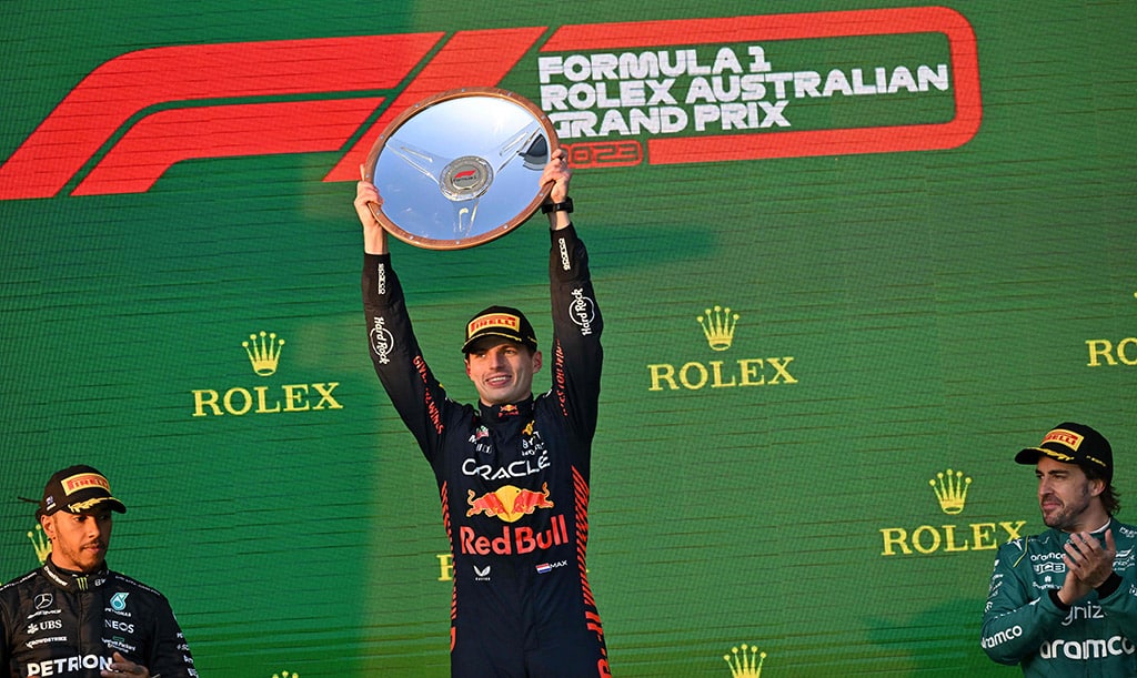 MELBOURNE: Red Bull Racing’s Dutch driver Max Verstappen celebrates victory with the trophy as second-placed Mercedes’ British driver Lewis Hamilton (left) and third-placed Aston Martin’s Spanish driver Fernando Alonso (right) clap for him on the podium after the 2023 Formula One Australian Grand Prix at the Albert Park Circuit on April 2, 2023. — AFP