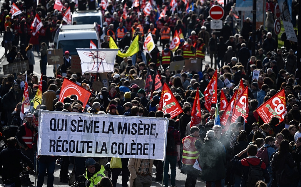 NANTES: In this file photo taken on March 15, 2023 protesters hold a banner reading “who sows misery reaps anger” during a demonstration on 8th day of strikes and protests across the country against the government’s proposed pensions overhaul in Nantes. — AFP