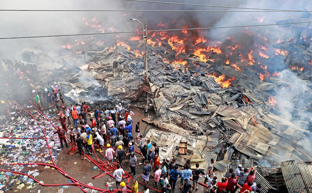 DHAKA: Firefighters try to extinguish a fire that broke out in a clothing market in Dhaka on April 4, 2023.nHundreds of firefighters were battling an immense blaze in the Bangladeshi capital as an inferno ragednthrough a popular clothing market. — AFP